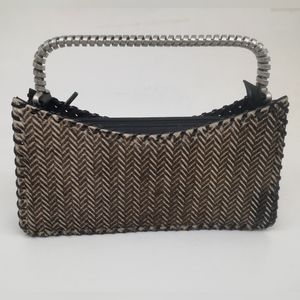 A Vintage Kenzo Clutch Purse with Chevron pattern on one side and black leather